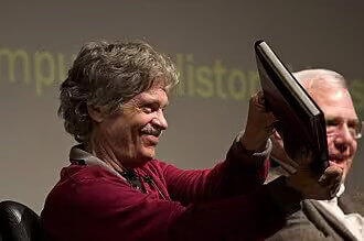 Alan Kay, holding the famous dynabook or the world's first notebook
